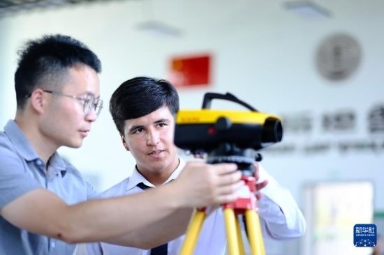 6月14日，在塔吉克斯坦首都杜尚別的魯班工坊，來自天津城市建設(shè)管理職業(yè)技術(shù)學(xué)院的老師（左）指導(dǎo)學(xué)生。新華社記者 鄭開君 攝
