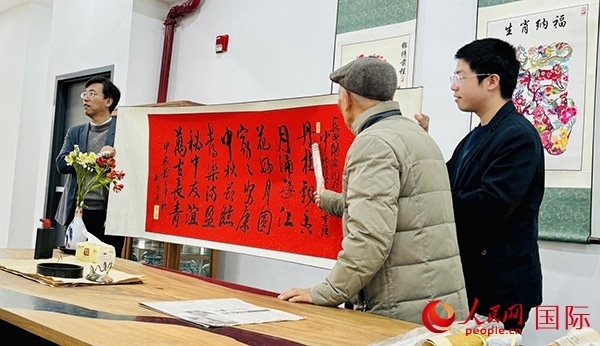 旅秘書法家向現(xiàn)場觀眾展示書法作品。人民網(wǎng)記者 宋亦然攝