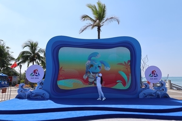 第12棒火炬手“點燃”現(xiàn)場大屏幕上運動會吉祥物“吉貝”手中的火炬。主辦方供圖