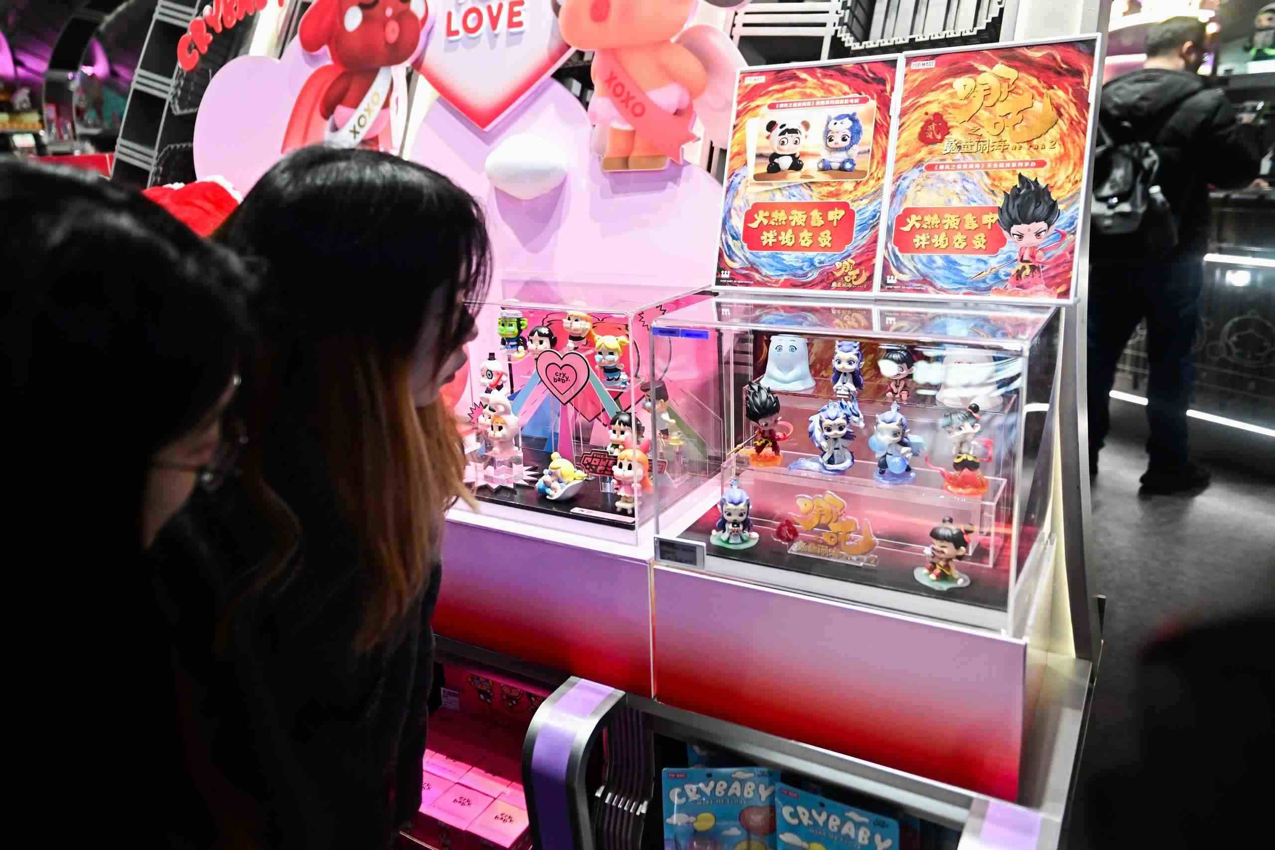 △2025年2月22日，上海，市民在圍觀《哪吒之魔童鬧?！废嚓P(guān)手辦盲盒。