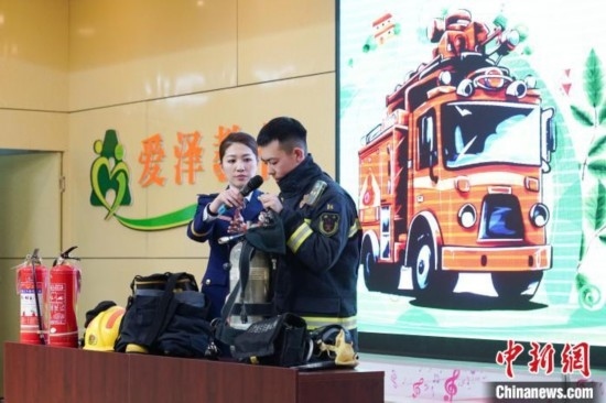 圖為消防員介紹消防裝備。中新社記者 趙宇航 攝